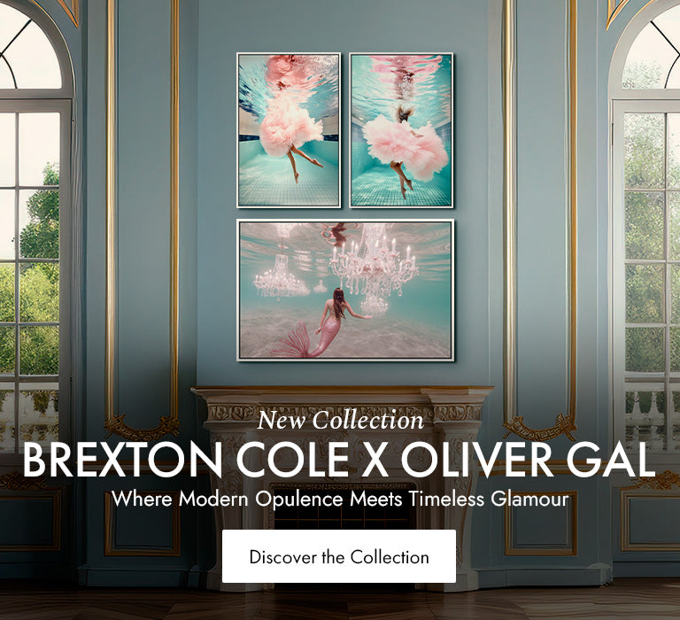 Brexton Cole x Oliver Gal collection wall art featuring three underwater-inspired prints with flowing pink fabric, displayed in a luxe room with teal walls and gold trim next to a tall arched window.